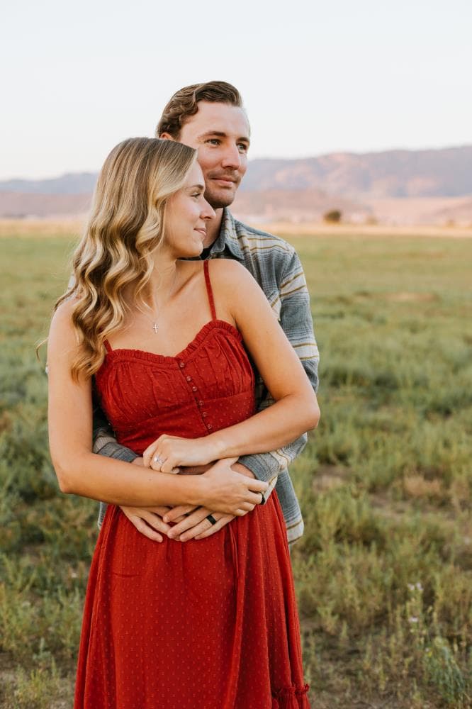 Couple laughing together golden hour engagement session Northern Colorado