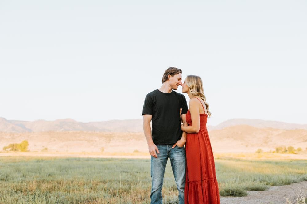 Couple laughing together golden hour engagement session Northern Colorado