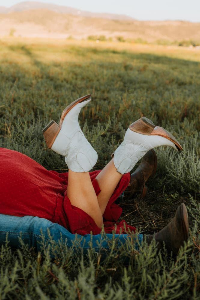 Couple laughing together golden hour engagement session Northern Colorado