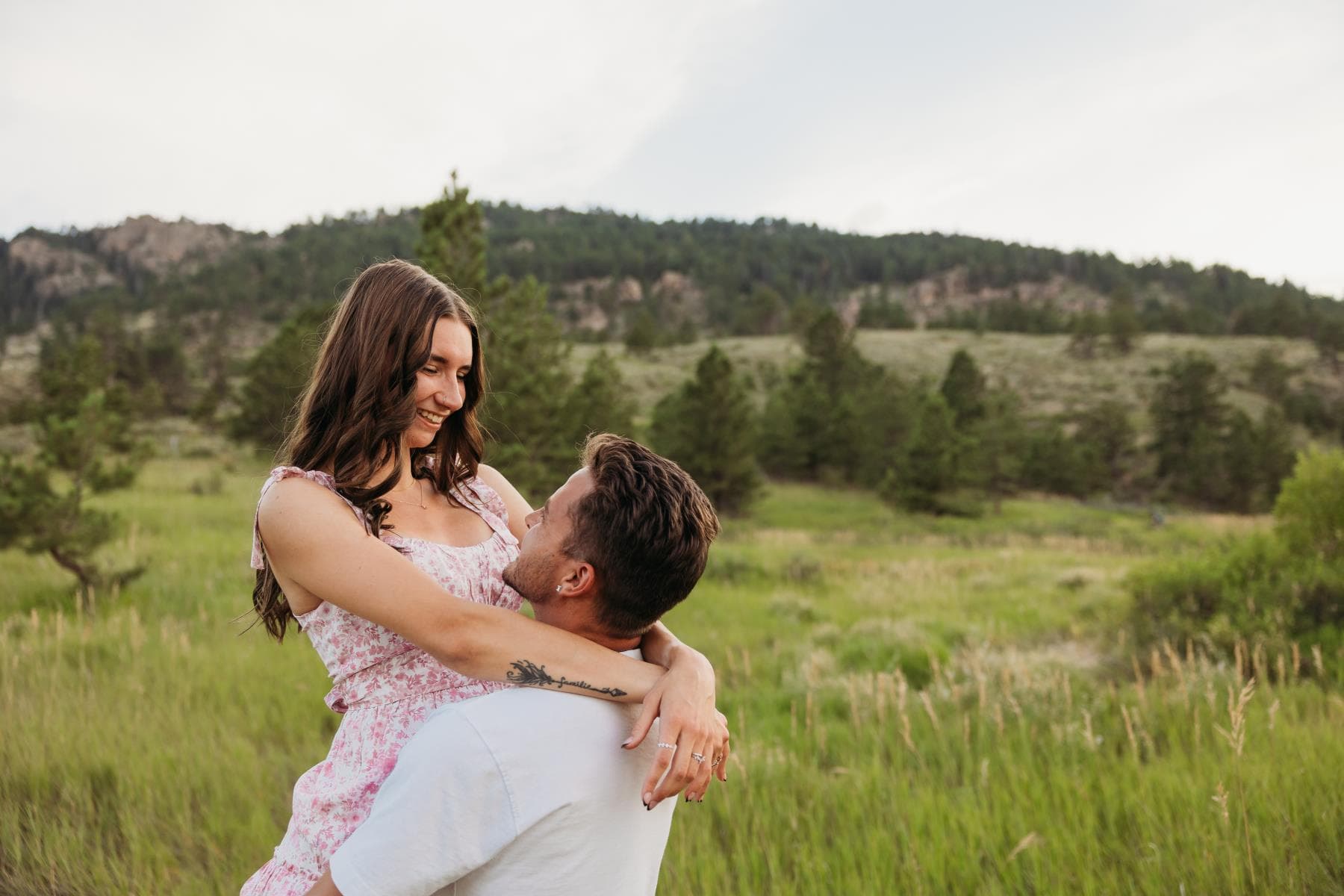 Couple laughing together golden hour engagement session Northern Colorado