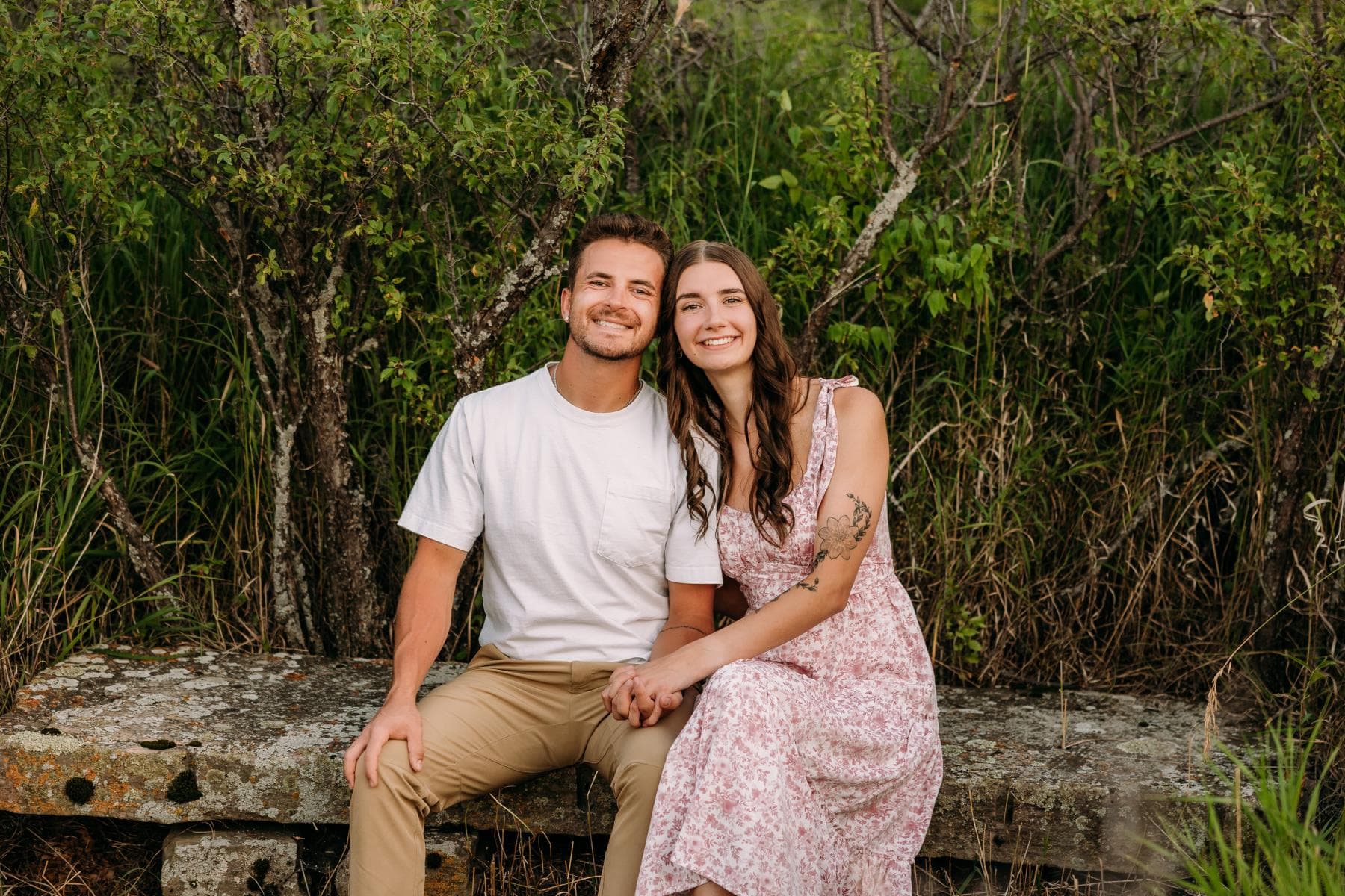 Engagement session couple kissing wildflower field Colorado