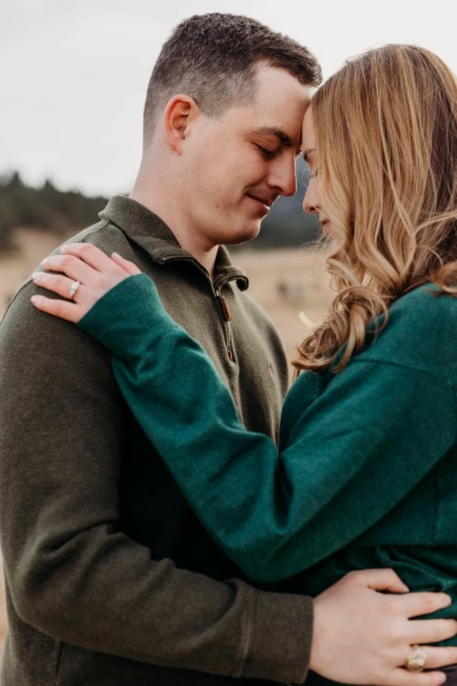 Couple embracing at sunset engagement photos Front Range Colorado