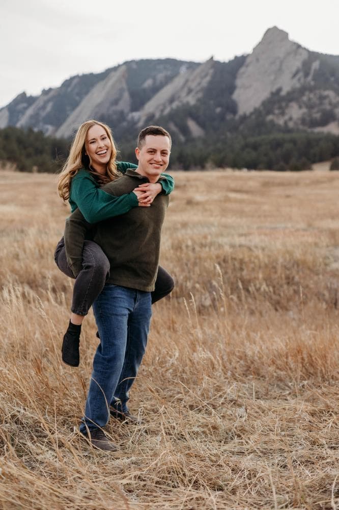 Couple laughing together golden hour engagement session Northern Colorado