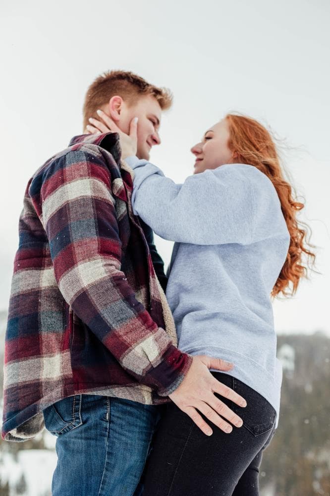 Couple laughing together golden hour engagement session Northern Colorado