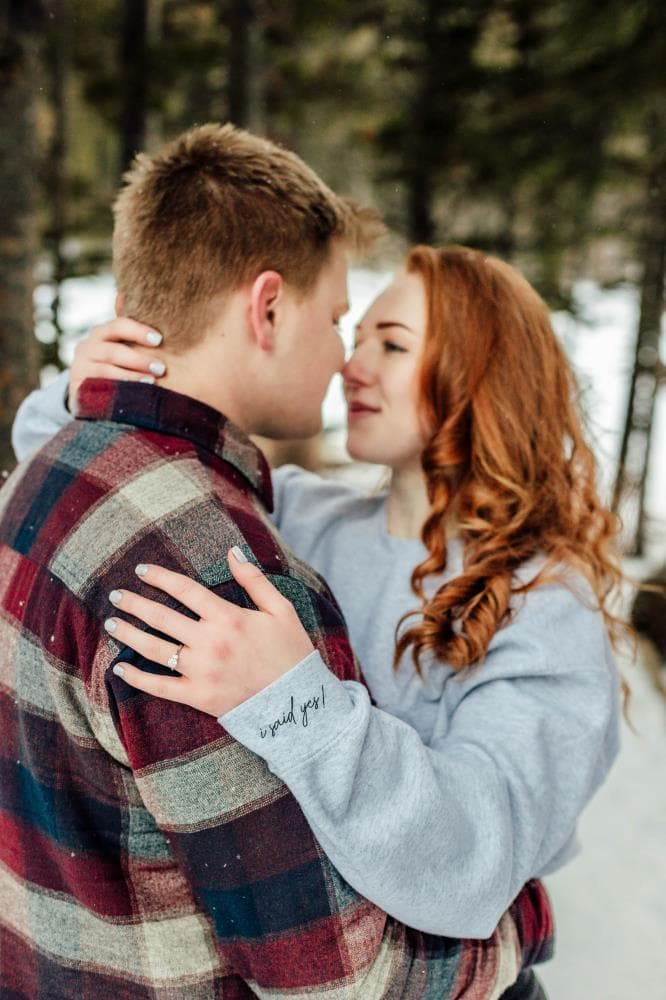 Couple laughing together golden hour engagement session Northern Colorado