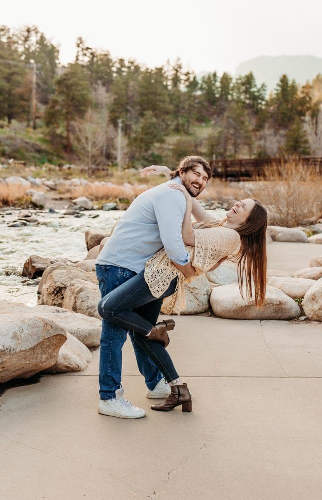 Couple laughing together golden hour engagement session Northern Colorado