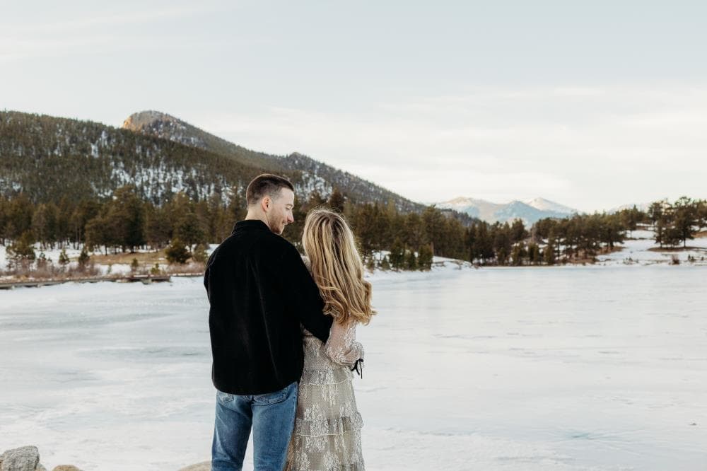 Engagement session couple kissing wildflower field Colorado