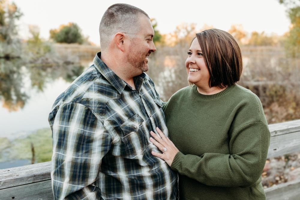 Engagement session couple kissing wildflower field Colorado