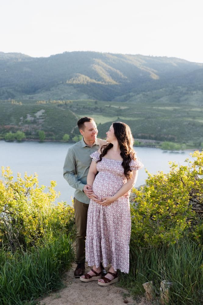 Pregnant mother cradling bump outdoor maternity session Northern Colorado