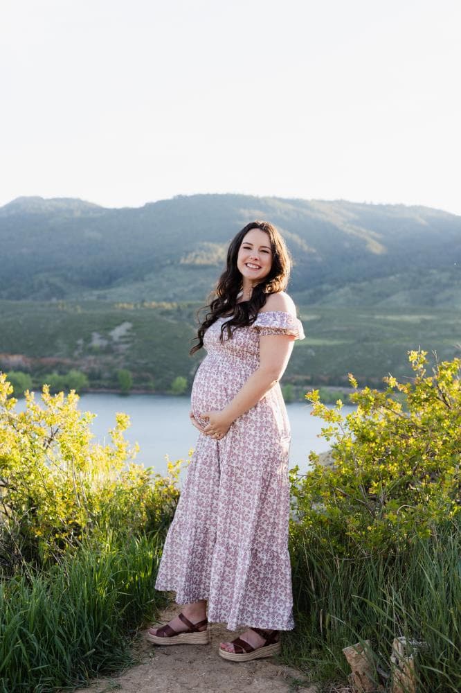 Pregnancy announcement outdoor session wildflower field Colorado