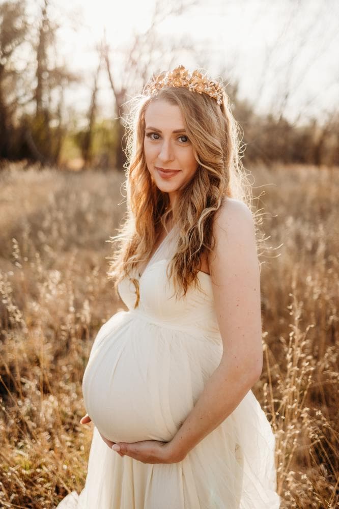 Pregnant mother cradling bump outdoor maternity session Northern Colorado