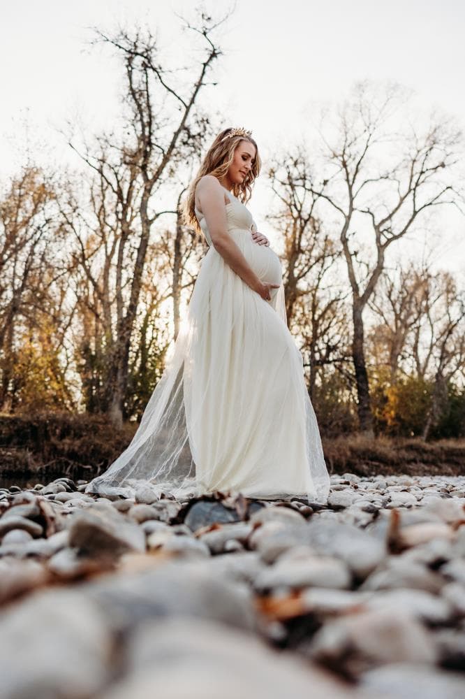 Pregnancy announcement outdoor session wildflower field Colorado