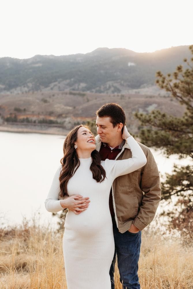 Pregnancy announcement outdoor session wildflower field Colorado