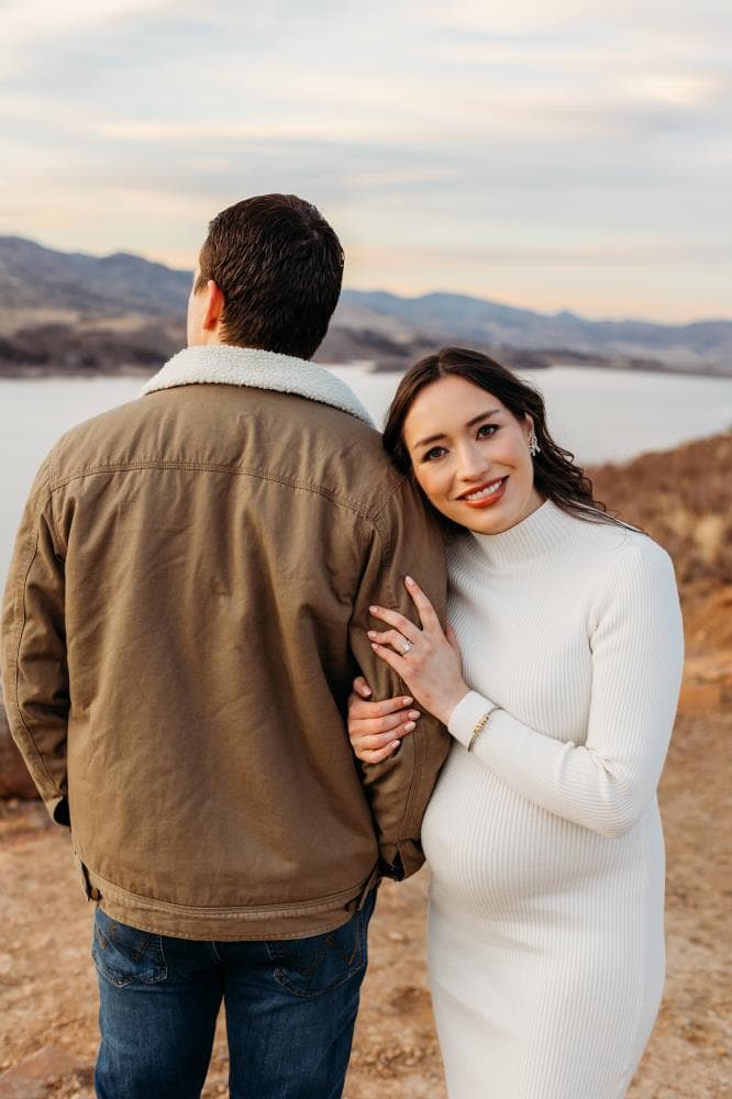 Pregnant mother cradling bump outdoor maternity session Northern Colorado