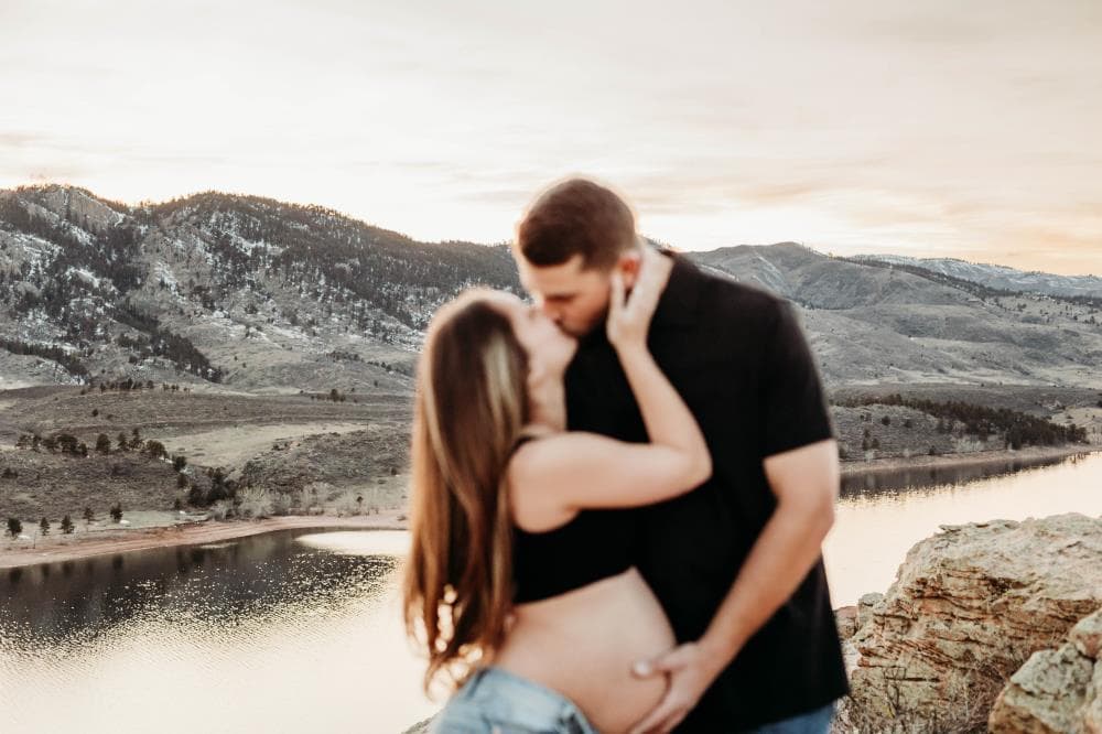 Pregnancy announcement outdoor session wildflower field Colorado