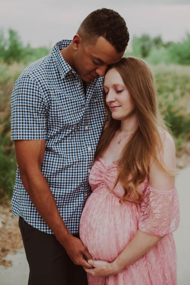Pregnant mother cradling bump outdoor maternity session Northern Colorado