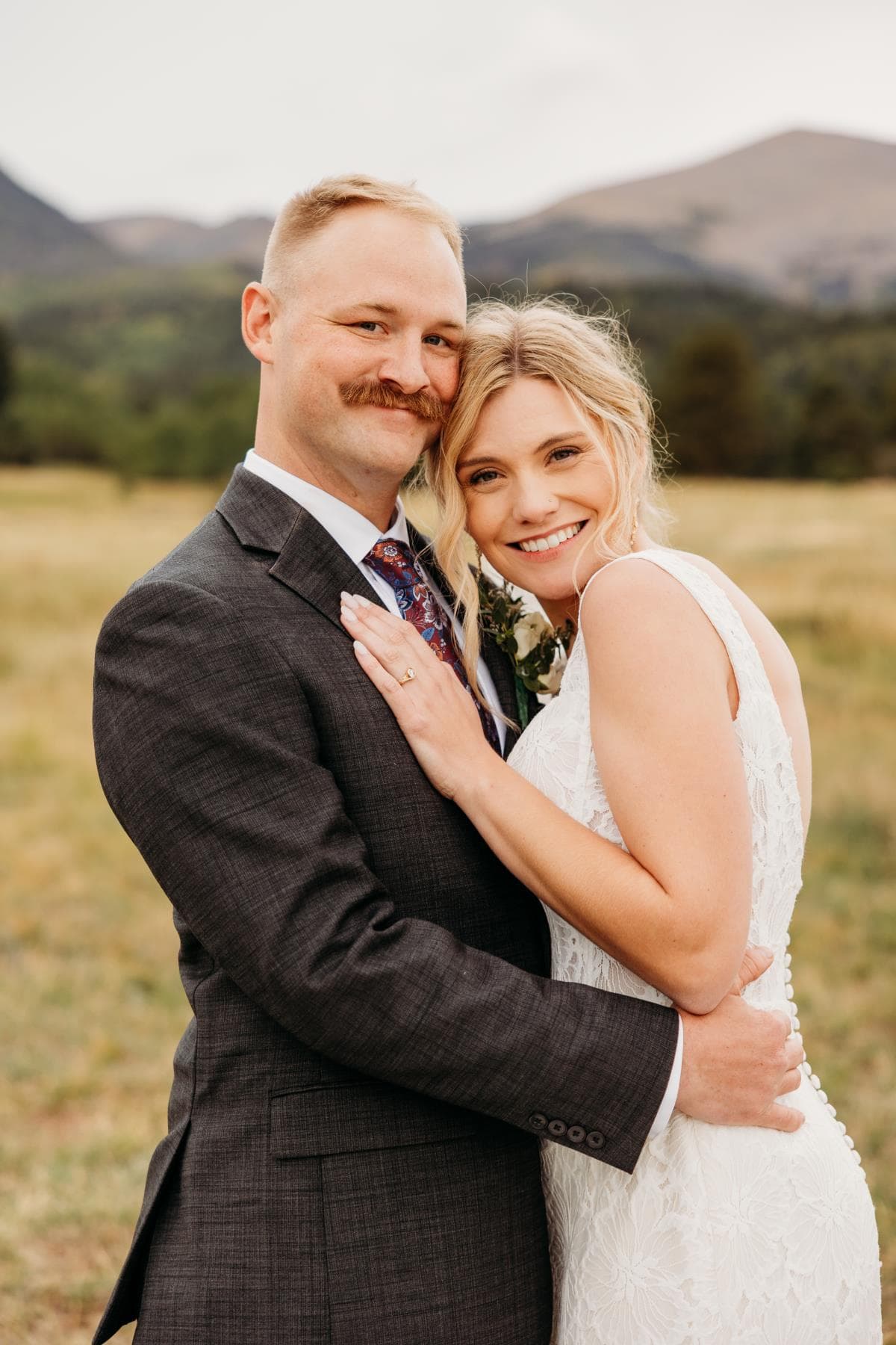 Newlyweds walking hand in hand at sunset Estes Park Colorado