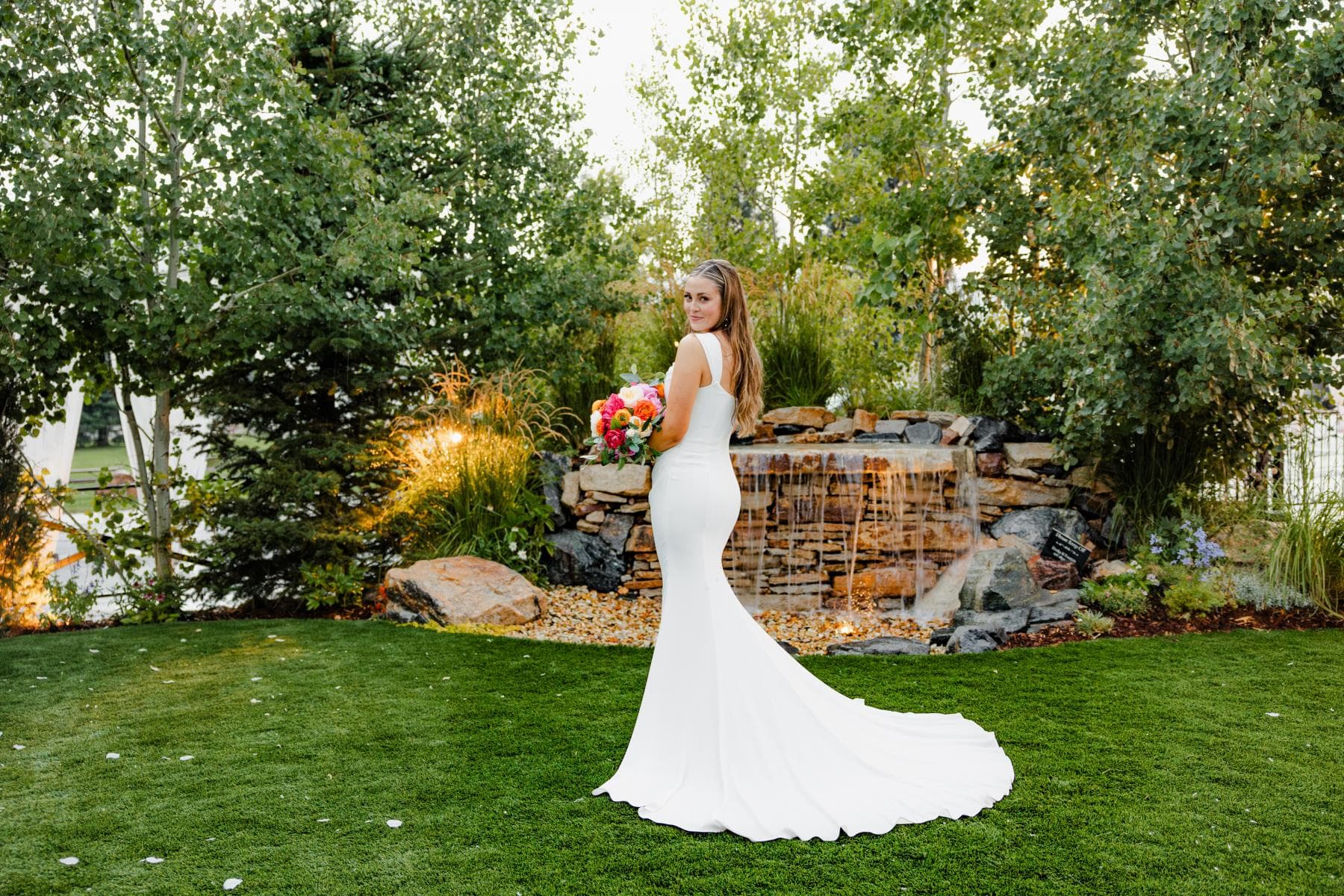 Bride and groom sharing first kiss at outdoor wedding ceremony Colorado