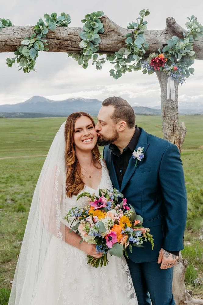 Newlyweds walking hand in hand at sunset Estes Park Colorado