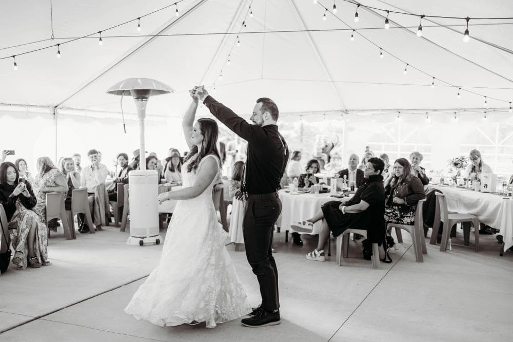 Bride and groom sharing first kiss at outdoor wedding ceremony Colorado