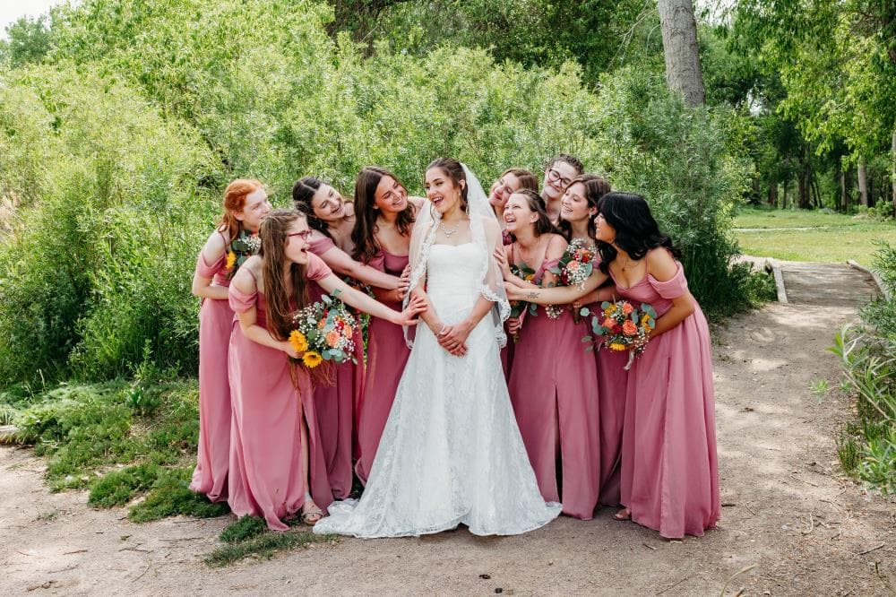 Bride and bridesmaids laughing getting ready Northern Colorado wedding day
