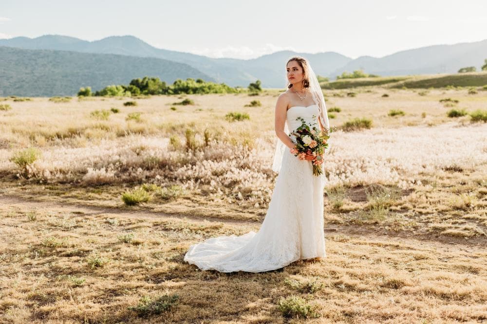 Newlyweds walking hand in hand at sunset Estes Park Colorado