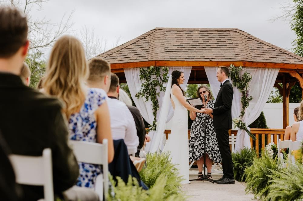 Bride and groom sharing first kiss at outdoor wedding ceremony Colorado